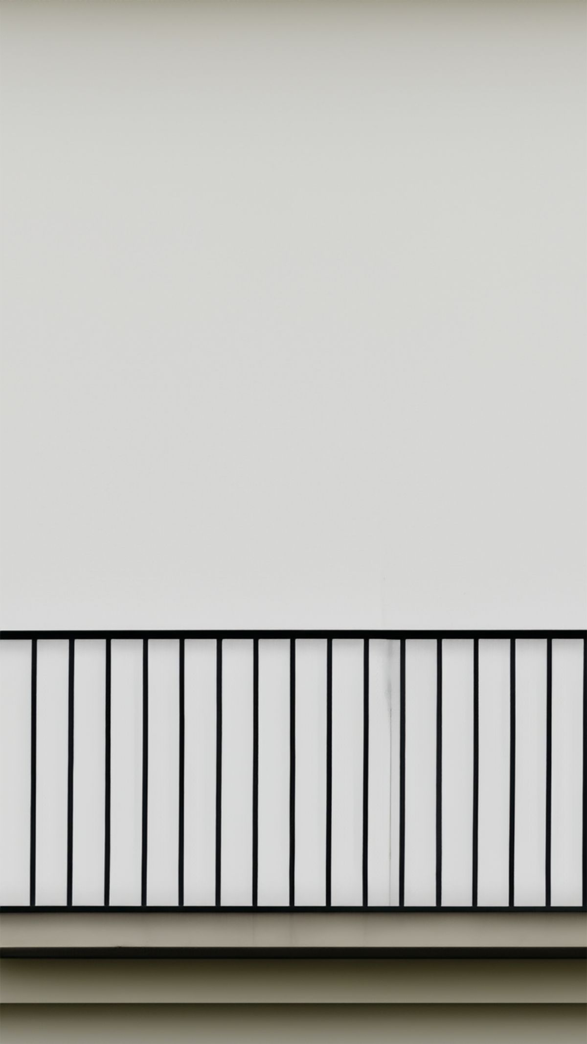 Modern black metal balcony railing with vertical bars